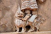 Chiang Mai - The Wat Phra Singh temple. The ho trai (temple library). The stucco figures in high relief of the base showing dancing Devas. 